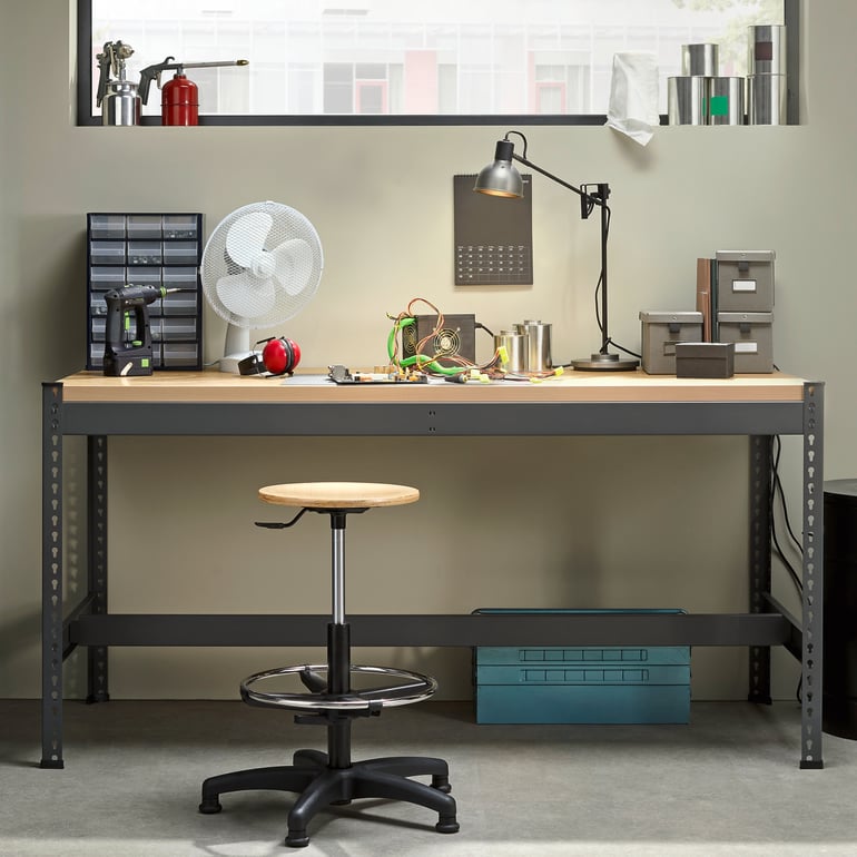 workbench with steel frame and wooden top with a workshop stool