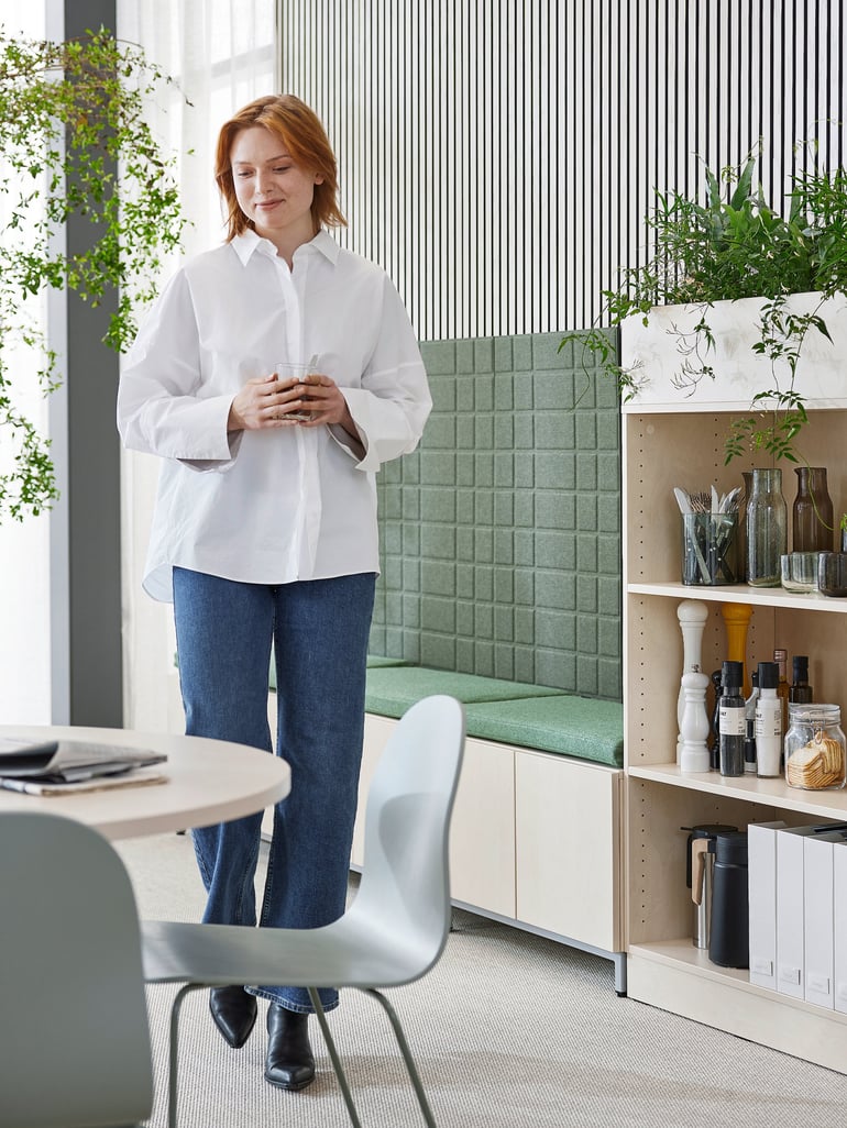 Woman going to sit at a table in an office dining area