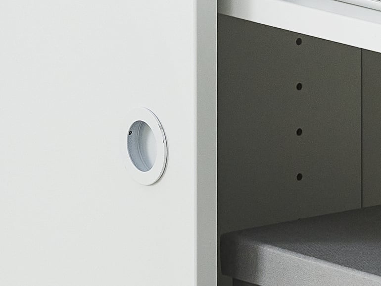 Close-up of cabinet door handle and internal space