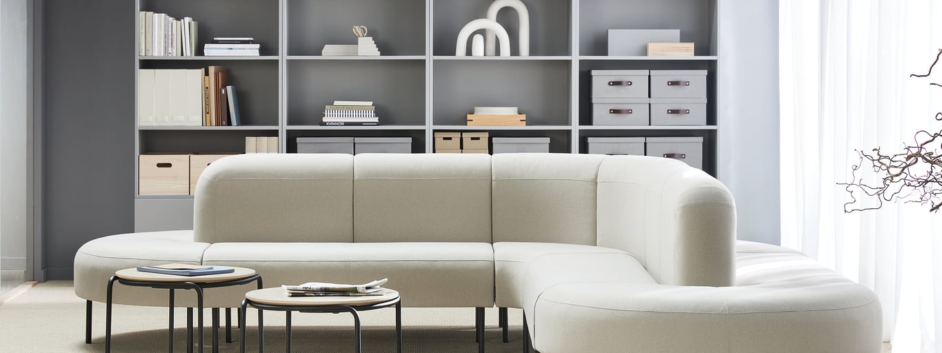 Sofa in common area with storage units against a wall