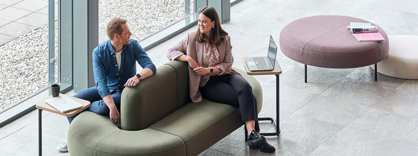 Two people chatting on a sofa