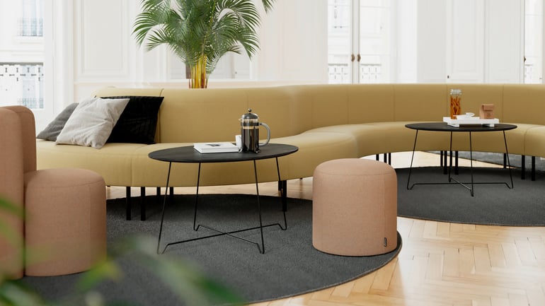 Long curved sofa with coffee tables and pouffes