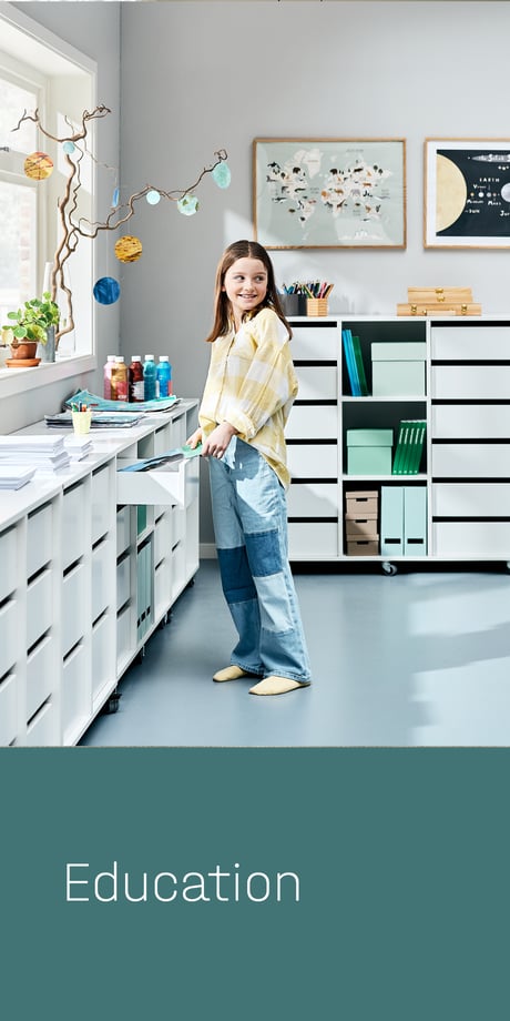 Education - child getting something out of a drawer in the classroom