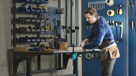 man working on workshop bench with tools