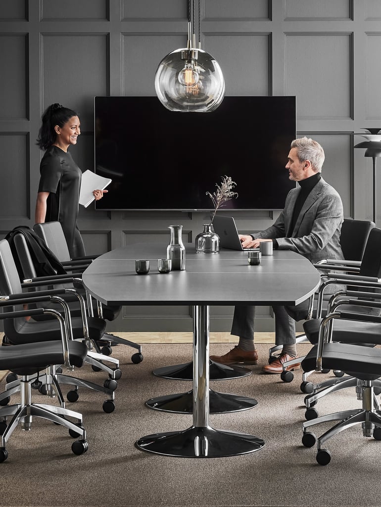 People talking at a conference room table