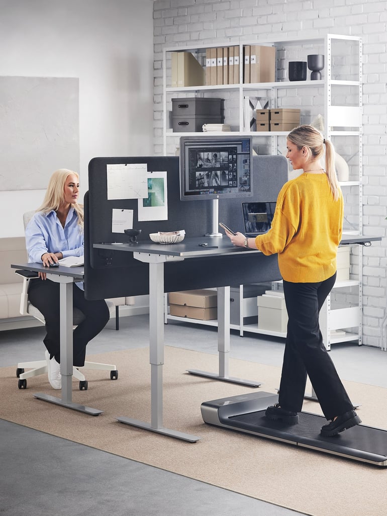 Woman walking on a treadmill at a desk