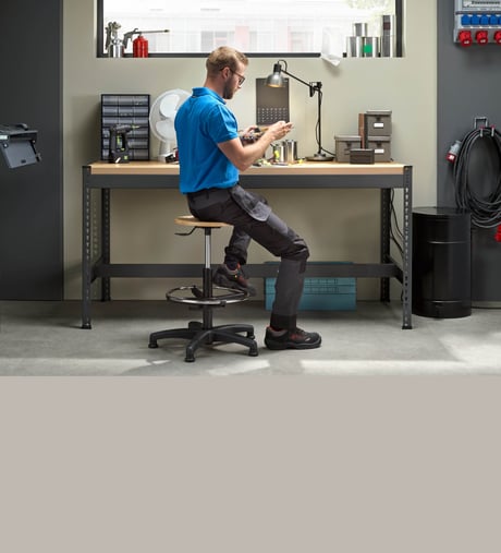Person doing assembly work at a workbench